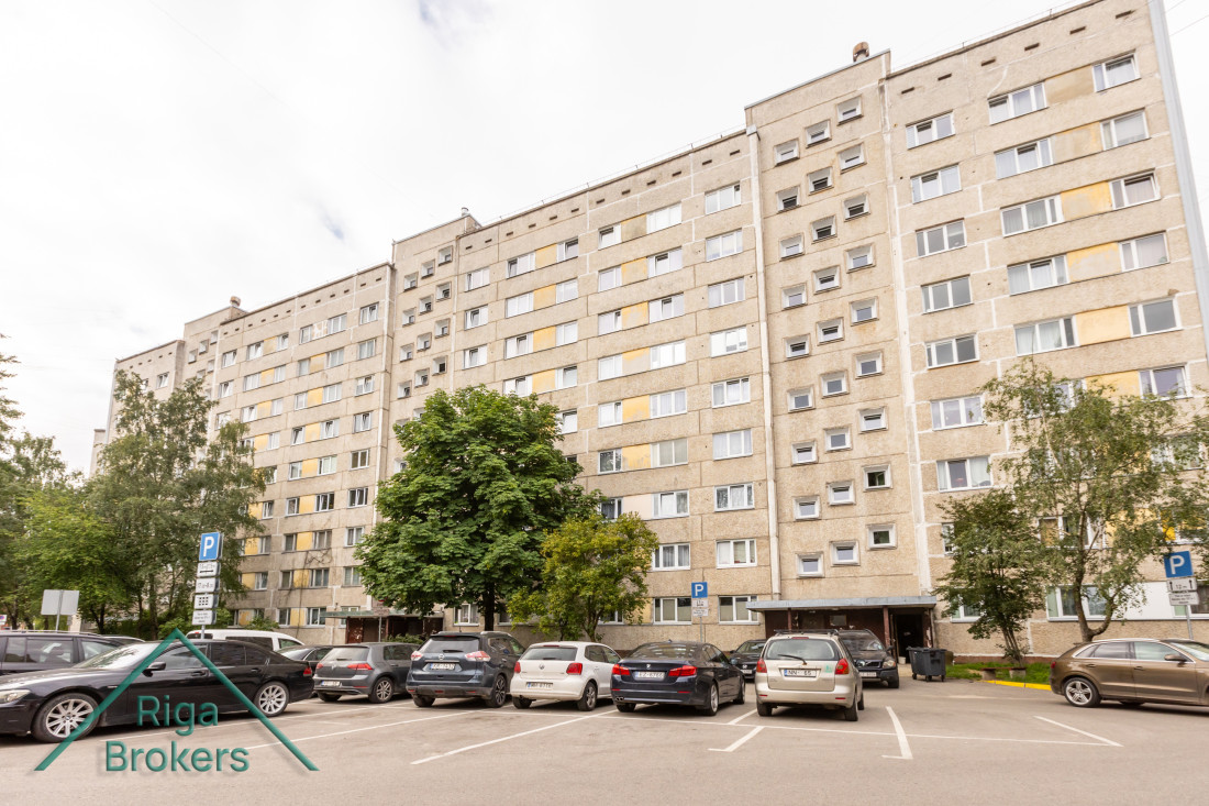 Apartment building with parking in front.