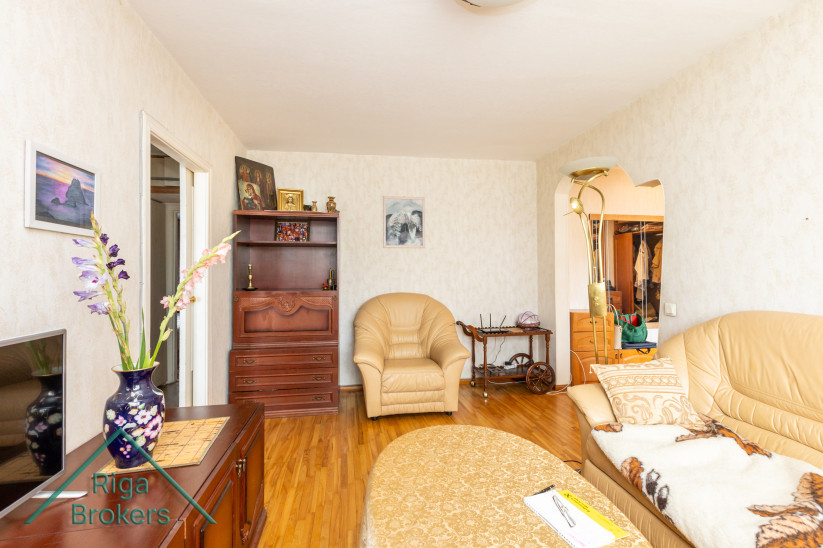 Living room with chair and shelf.
