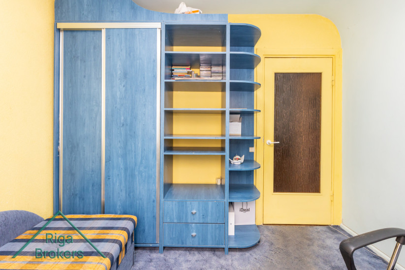 Room with a blue bookshelf.