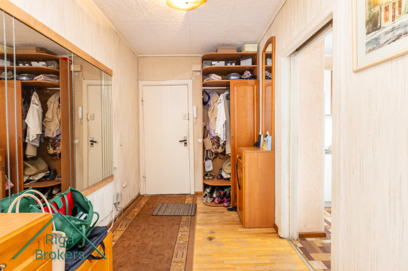 Entrance hall with wardrobes and large mirror.