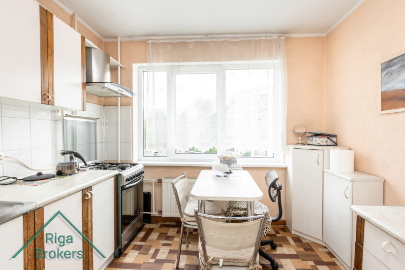 Kitchen with window and worktops.