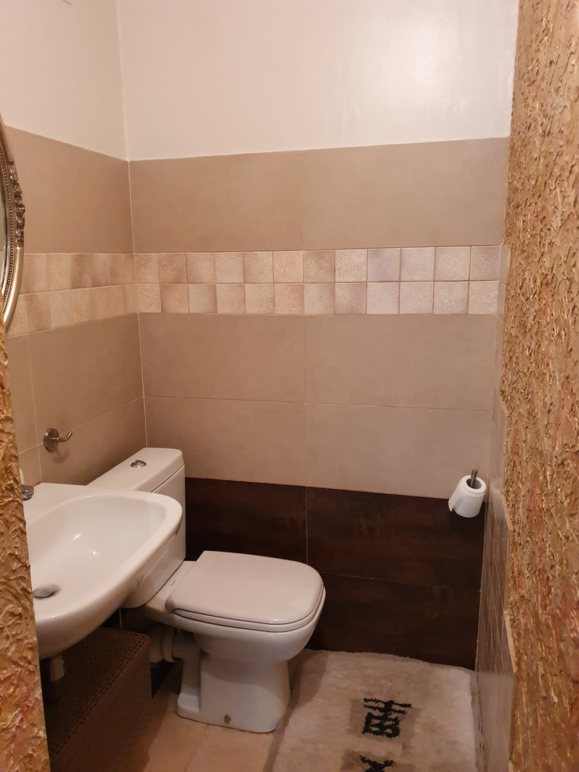 Compact toilet with neutral interior design.