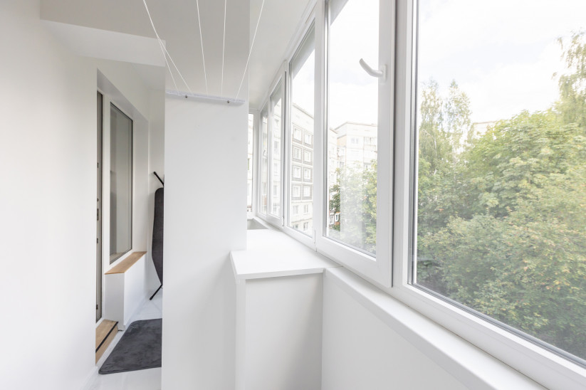 Bright balcony with large windows.