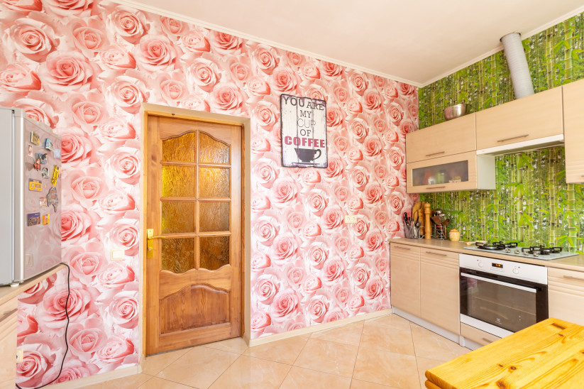 Kitchen with pink rose wallpaper.