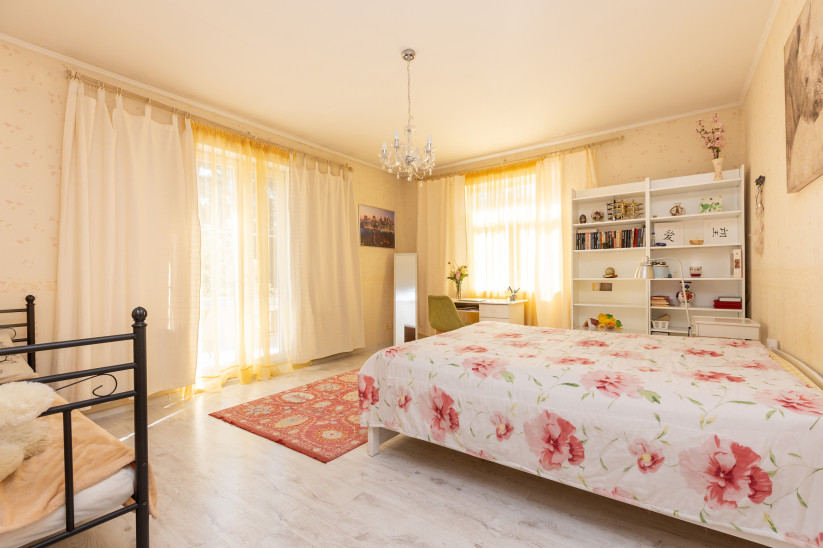 Bright bedroom with shelves and windows.