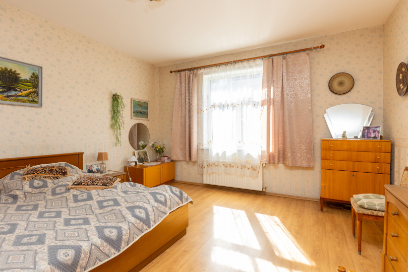 Bedroom with large window and furniture.