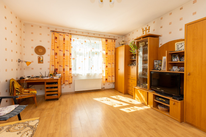 Room with yellow curtains and desk.