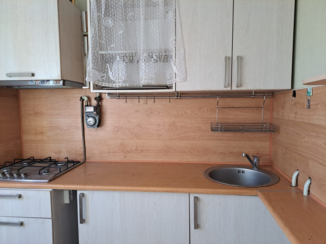Kitchen with gas stove and window.