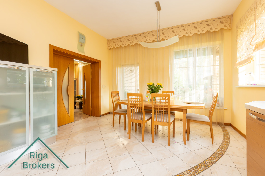 Dining room with table and large windows.