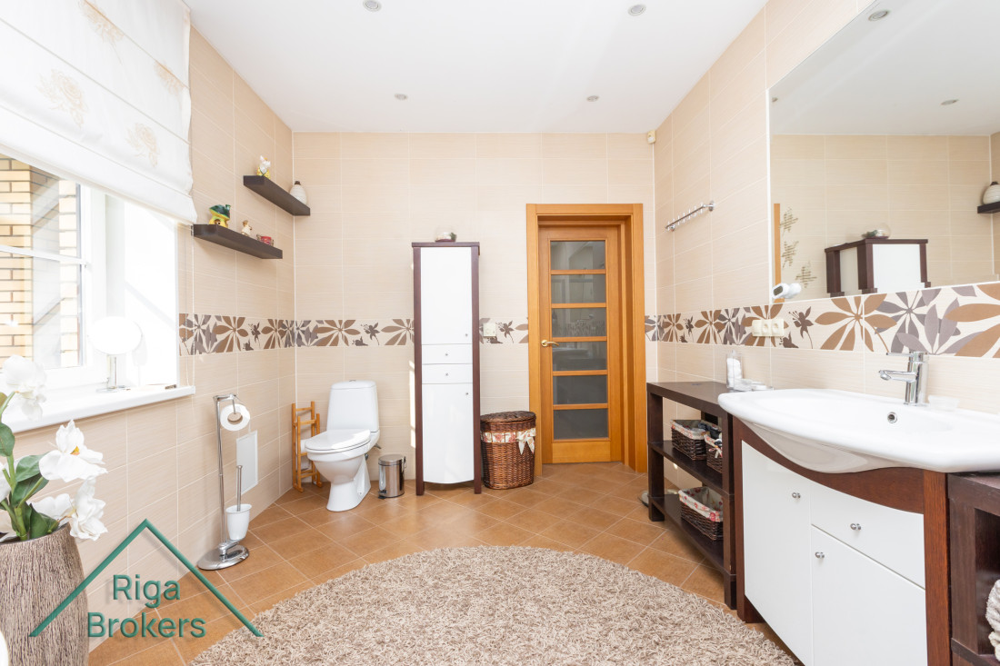 Bathroom interior with neutral colors and a rug.