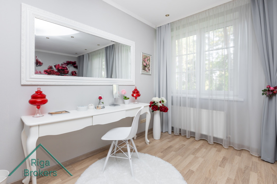 Vanity table with a large mirror and decorations.