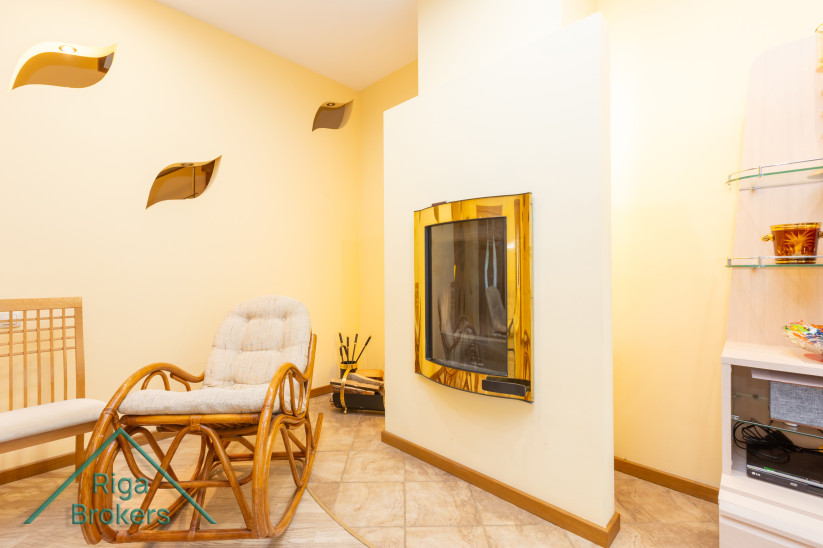 Rocking chair near fireplace in living room.