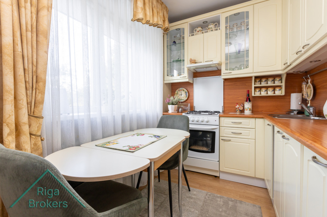 Kitchen with a window and dining table.