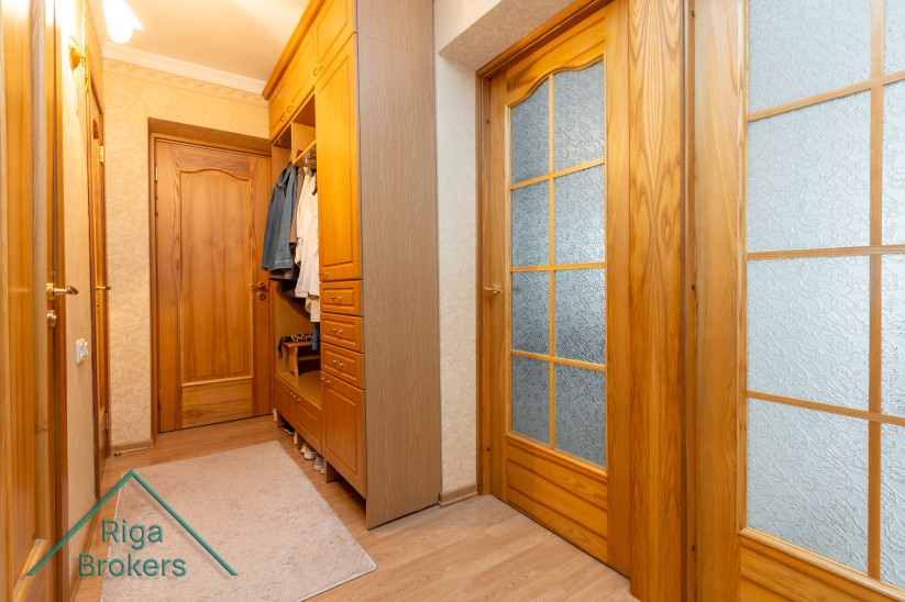 Hallway with wooden doors and wardrobes.