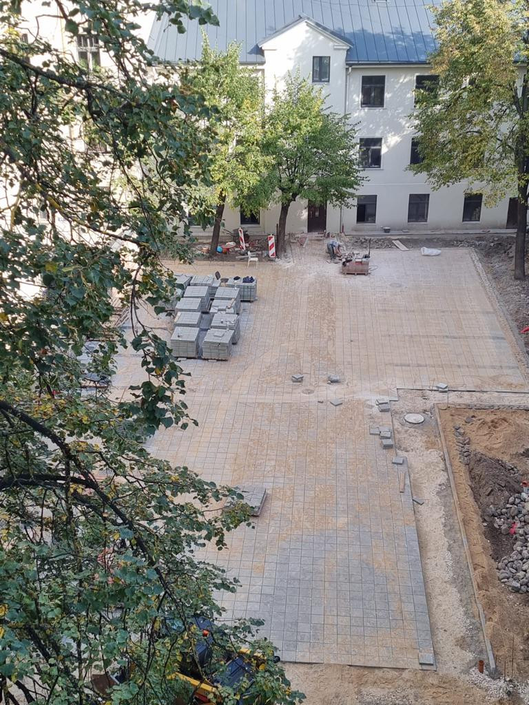 Courtyard with paving work in progress.