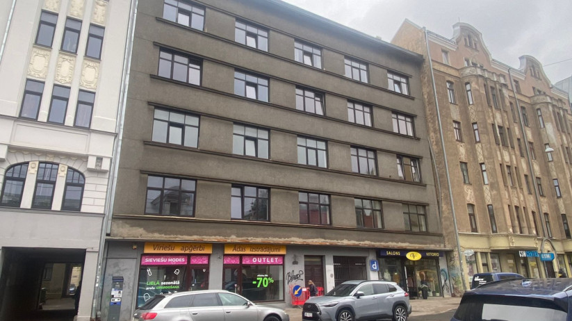 Multi-story building with gray facade.