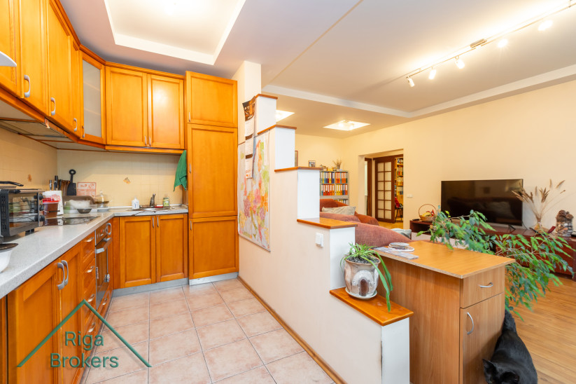 Kitchen with wooden cabinets and open layout.
