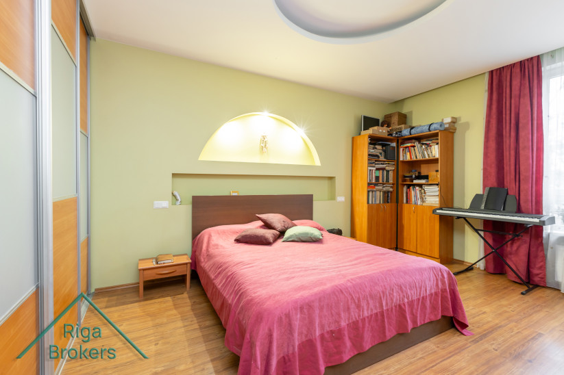 Bedroom with shelves and piano.