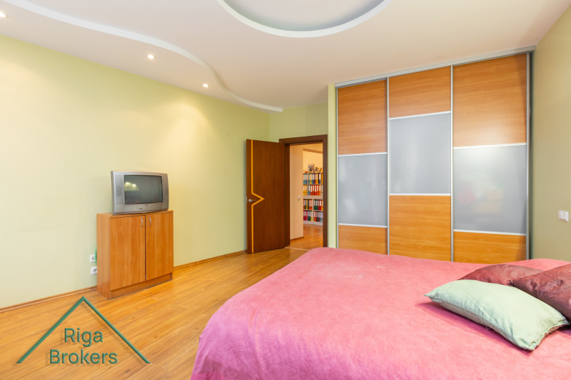 Bedroom with large bed and wardrobe.
