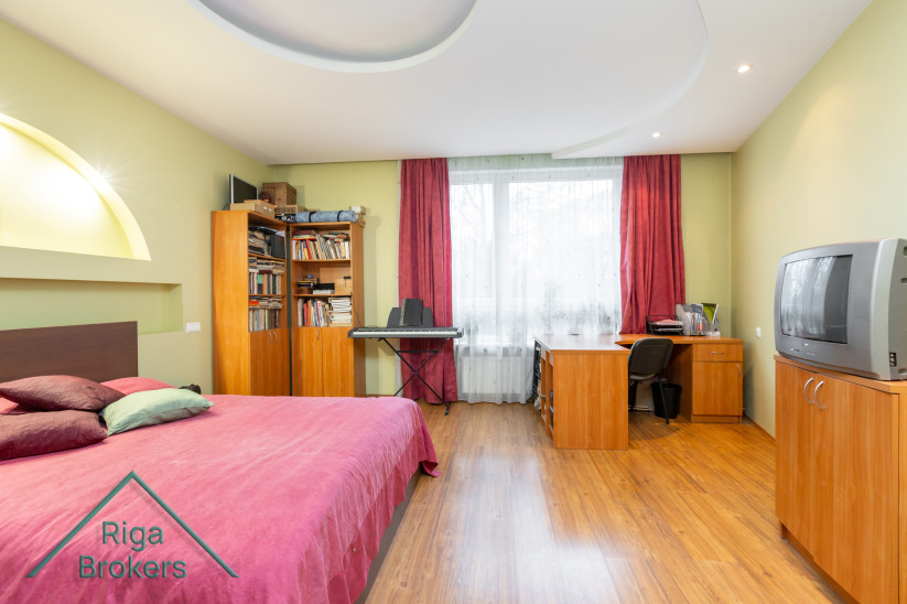 Bright bedroom with a work area.