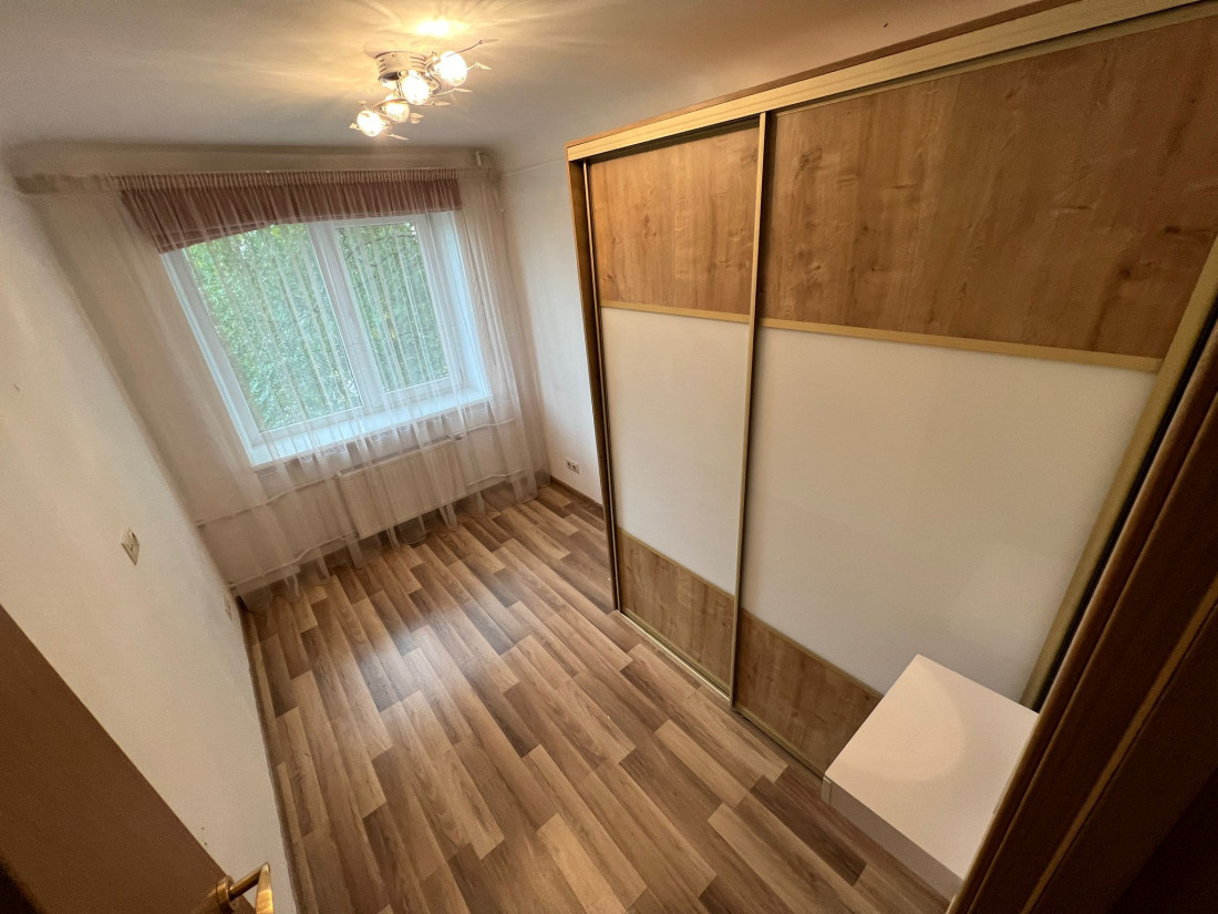 Bedroom with large windows and closet.