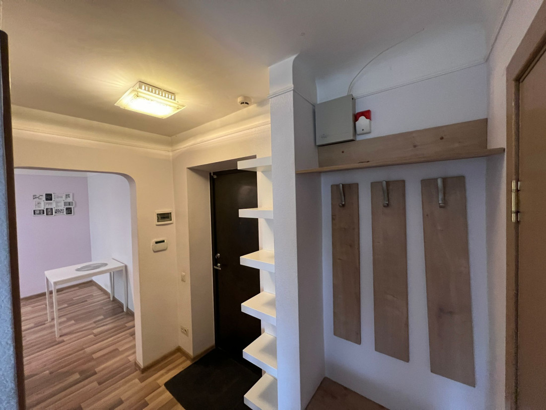 Hallway with coat rack and shelves.