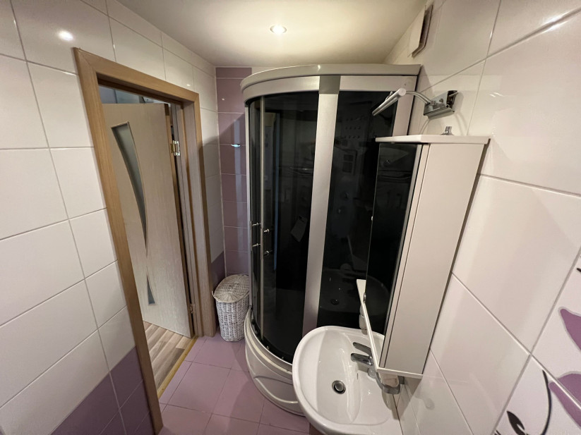 Small bathroom with shower cabin.