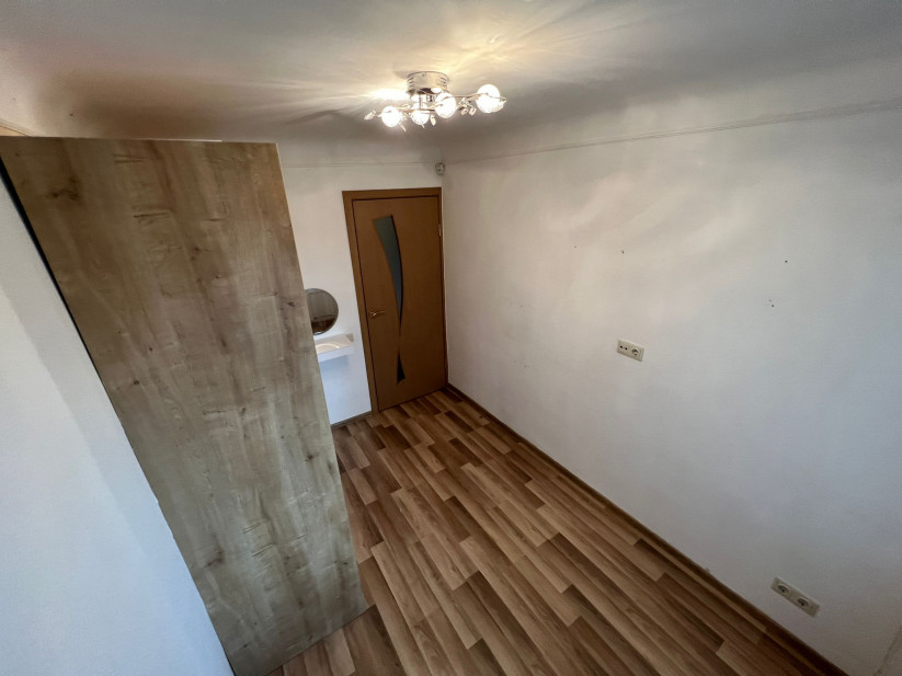 Bedroom with modern decor and door.