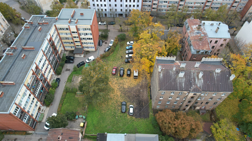 Apbūvēts kvartāls ar automašīnu stāvlaukumu.