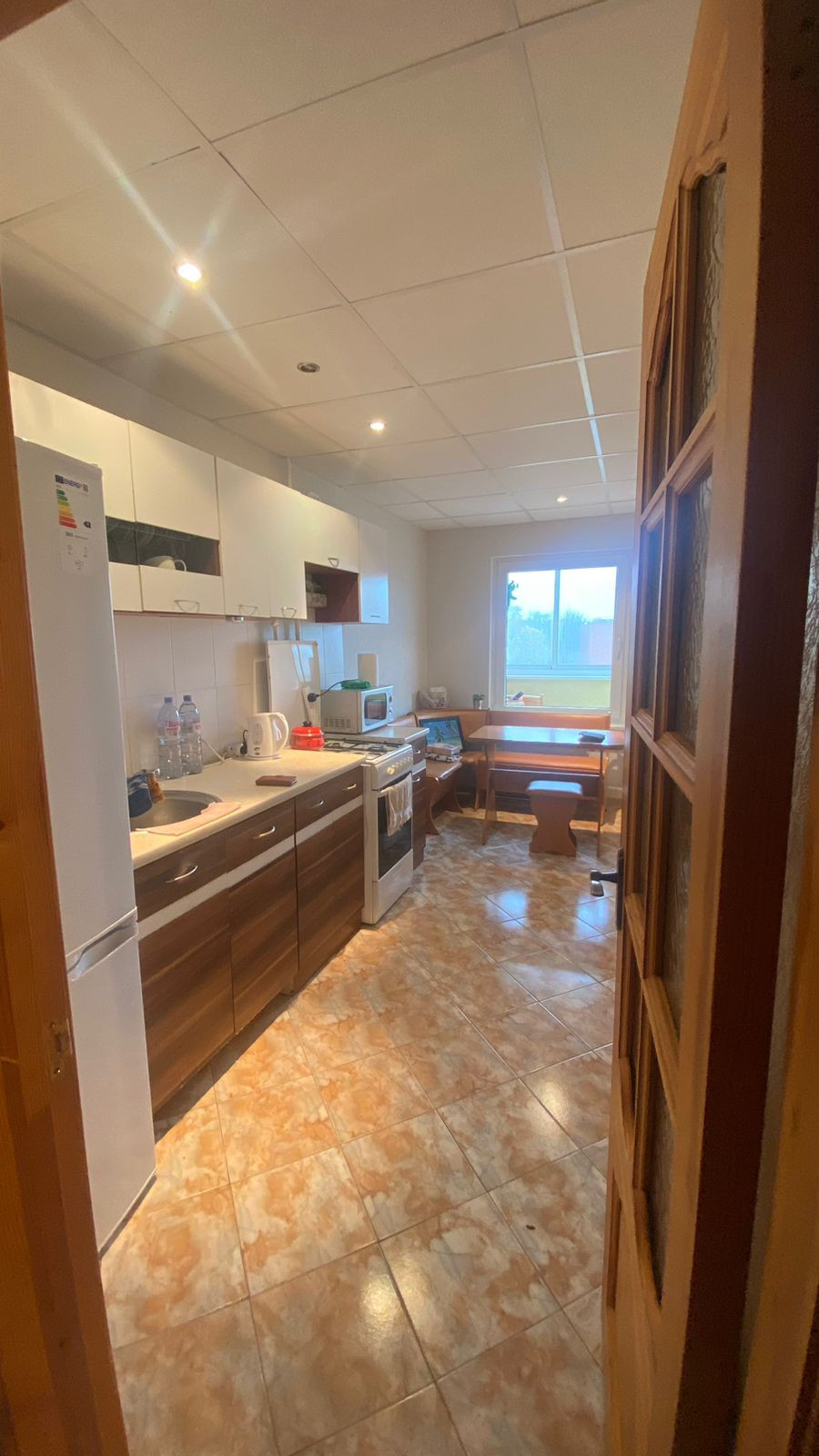 Kitchen with furniture and outdoor view.
