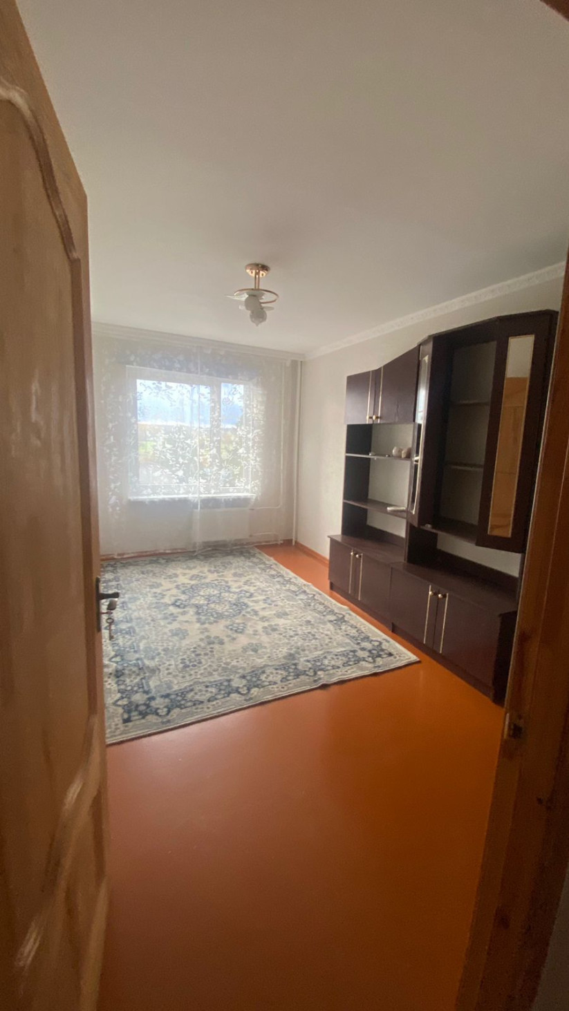 Room with furniture and blue patterned carpet.