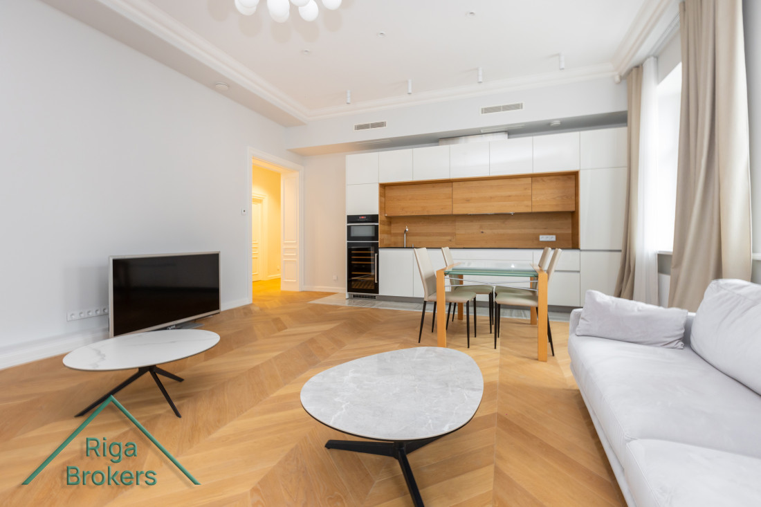 Spacious living room with open kitchen and dining area.