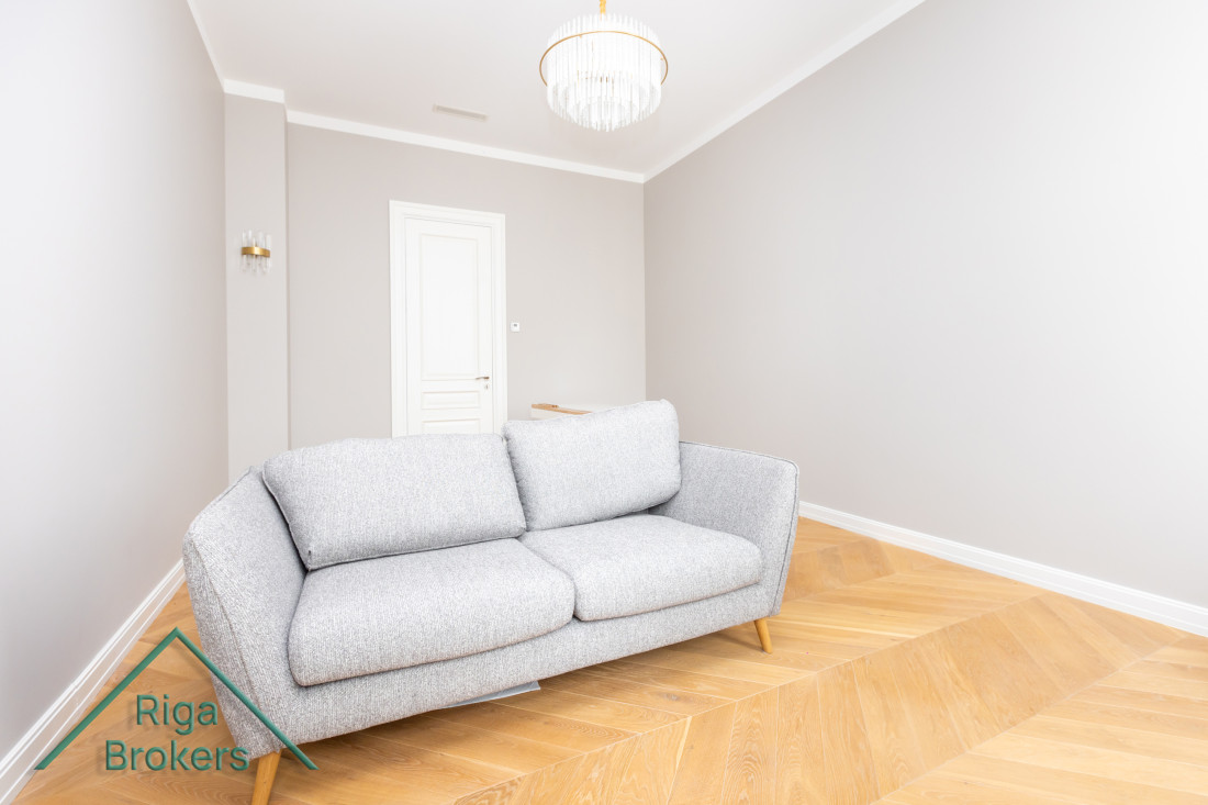Grey sofa in a bright minimalist room.