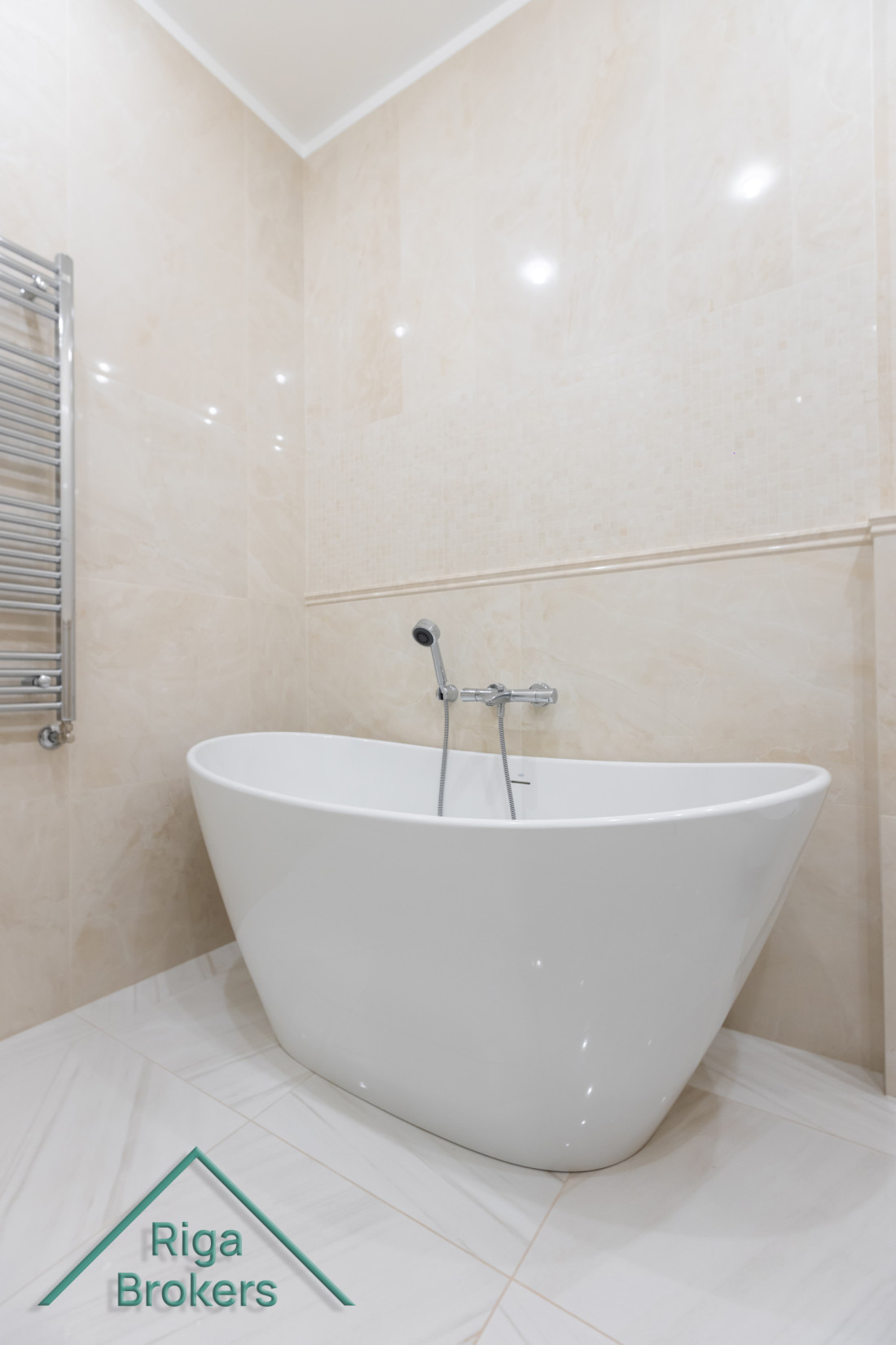 Stylish freestanding bathtub in bright bathroom.
