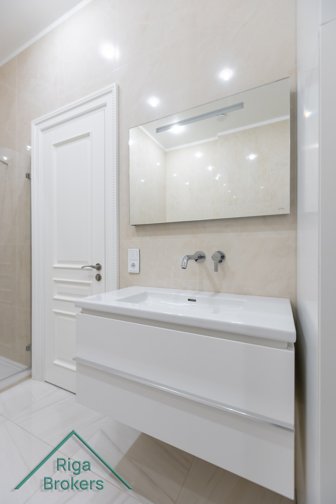 Bathroom sink with large mirror.