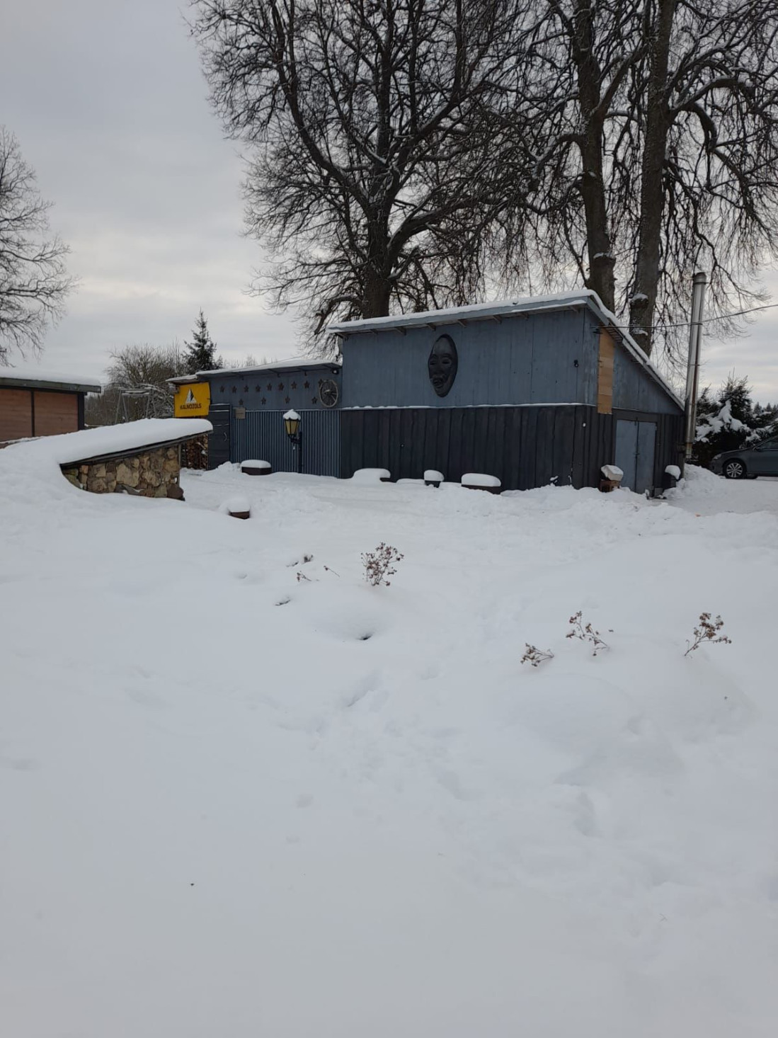 Winter scenery with a wooden shed.