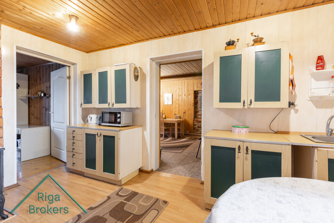 Kitchen with wooden ceiling and cabinets.