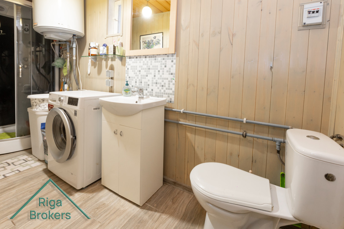 Modern bathroom design with a washing machine.