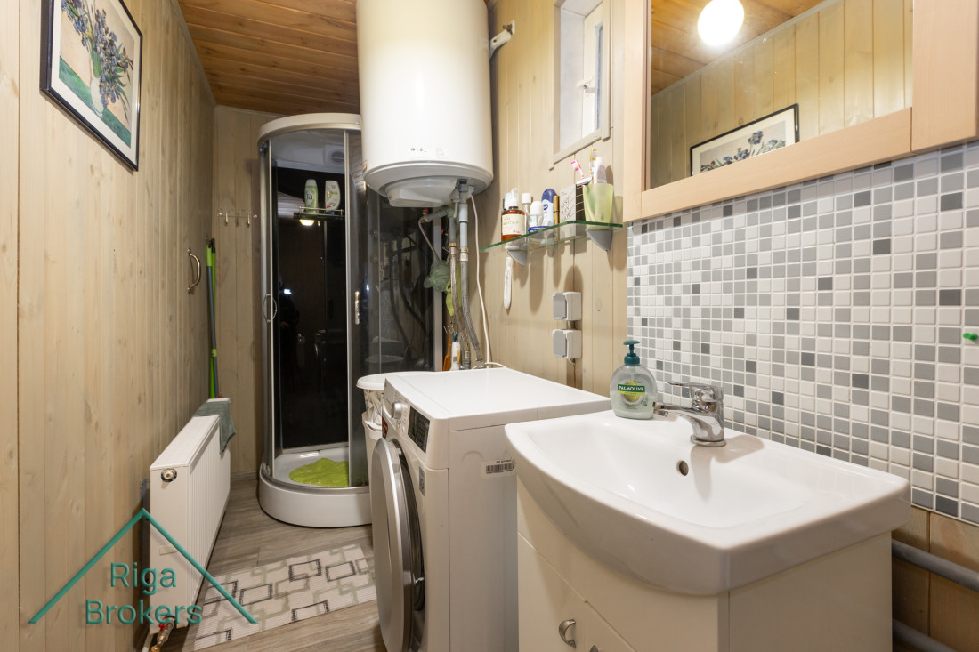 Bathroom with shower and washing machine.