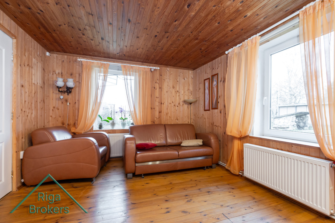 Lounge with leather furniture and windows.