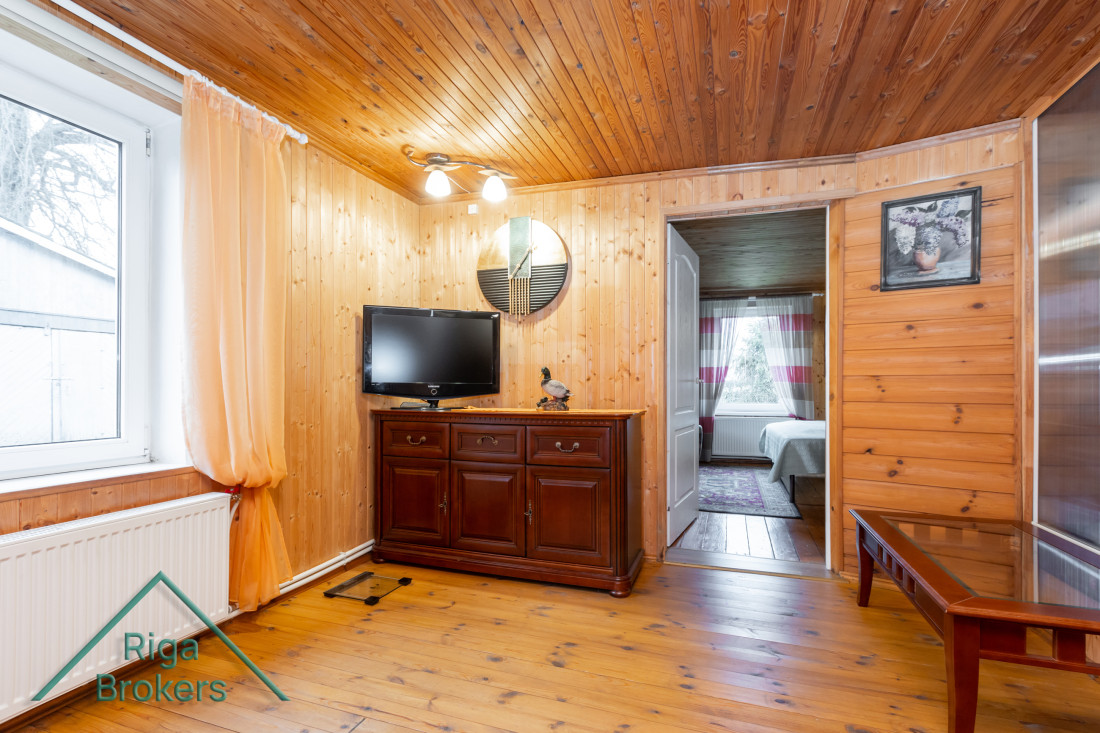Bedroom with wooden walls and window.