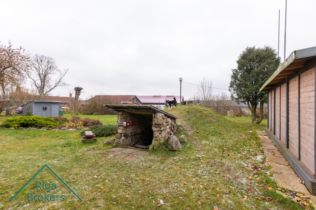 Earth cellar with entrance and lawn.