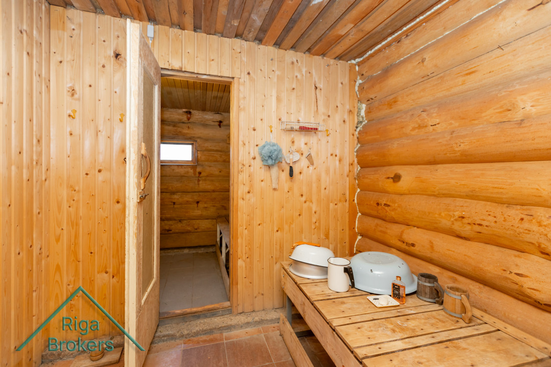 Sauna with wood-heated stove and bench.