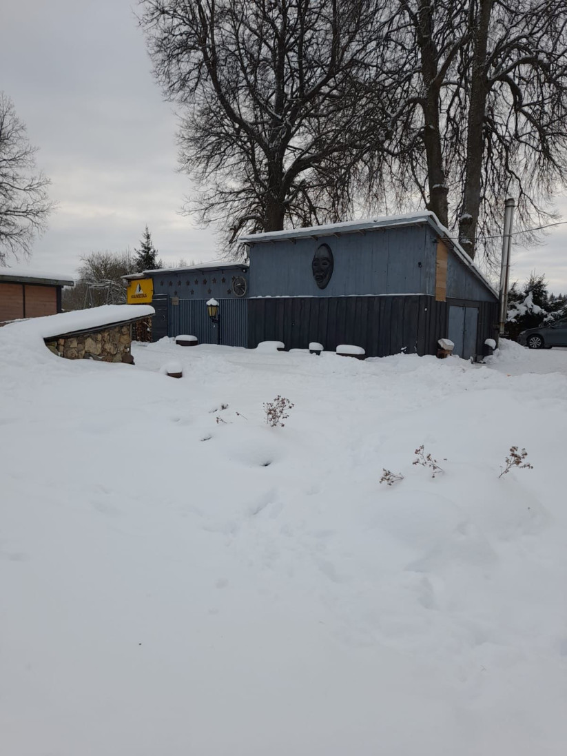 Winter scenery with a wooden shed.