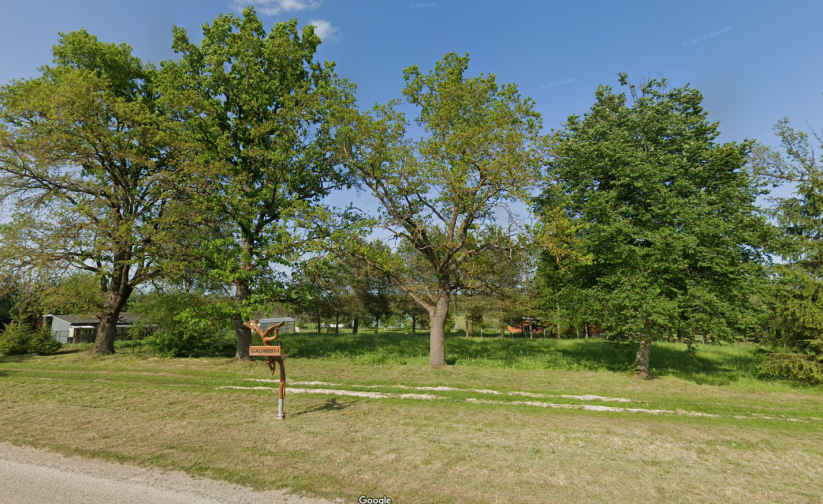 Road sign in a green landscape.