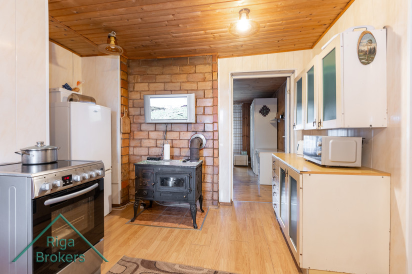 Kitchen with a wood stove and modern appliances.