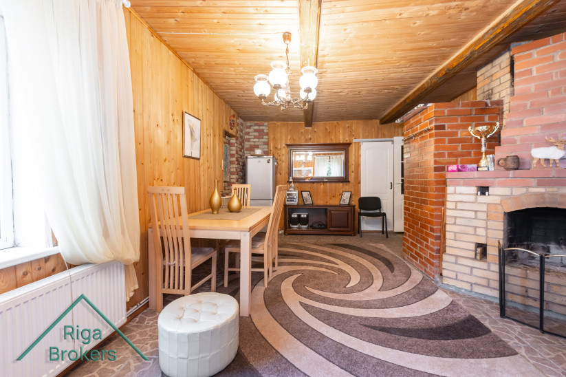 Dining area with wooden decor and fireplace.