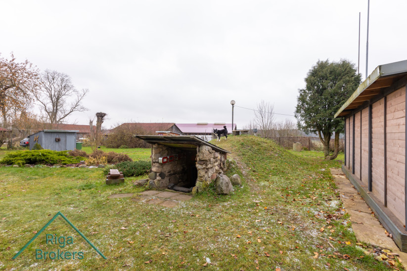 Earth cellar with entrance and lawn.