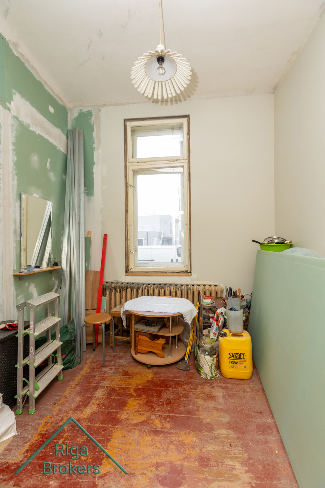 Room with red floor and radiator.