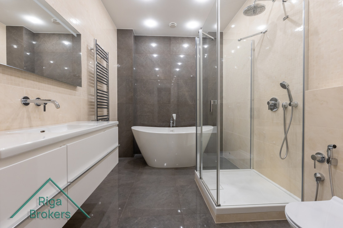 Modern bathroom with tub and shower.